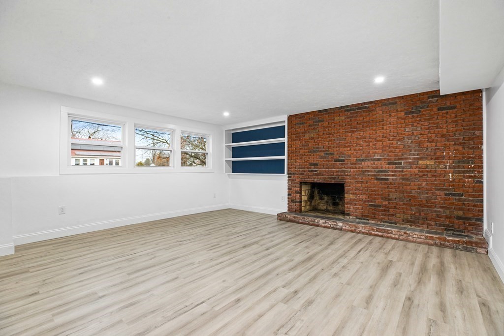 216 Grove Street Randolph, MA 02368 - Photo 24 of 34 an empty room with windows and fireplace