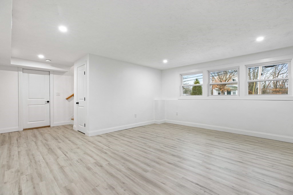 216 Grove Street Randolph, MA 02368 - Photo 25 of 34 an empty room with wooden floor and windows