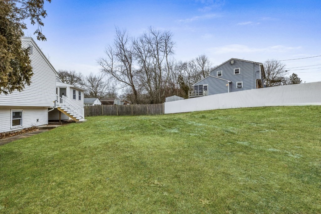 216 Grove Street Randolph, MA 02368 - Photo 29 of 34 a front view of house with yard and trees in the background
