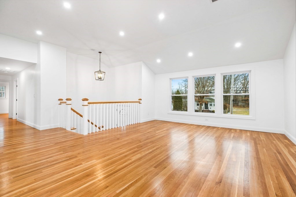 216 Grove Street Randolph, MA 02368 - Photo 4 of 34 a view of an empty room with wooden floor and a window