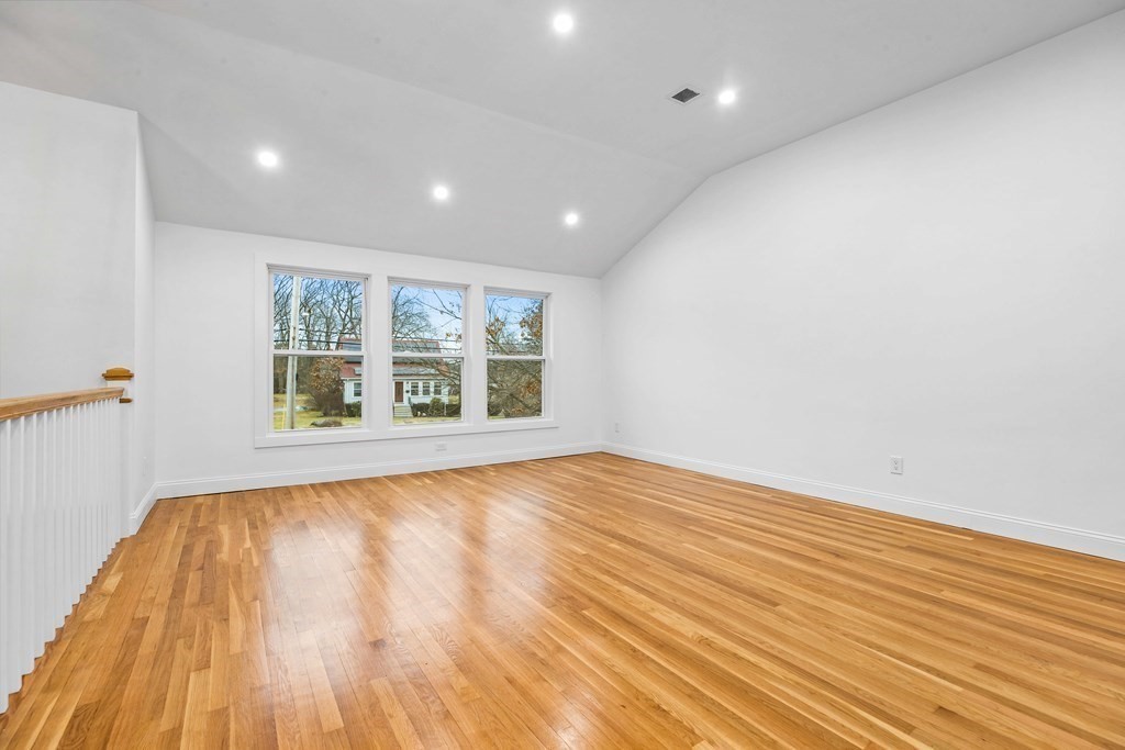 216 Grove Street Randolph, MA 02368 - Photo 6 of 34 a view of an empty room with wooden floor and a window