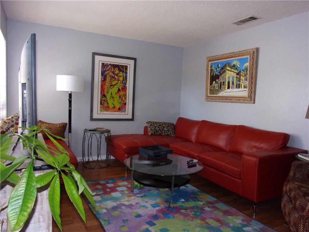 18240 Midway Road, Unit 105 Dallas, TX 75287 - Photo 7 of 37 a living room with furniture and a baby crib