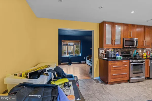 a kitchen with stainless steel appliances granite countertop a stove and a refrigerator
