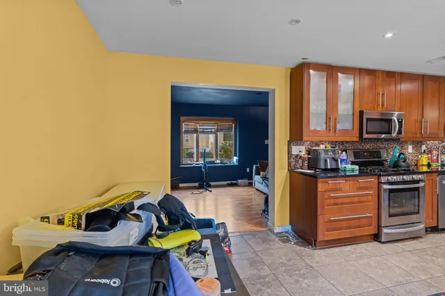 a kitchen with stainless steel appliances granite countertop a stove and a refrigerator