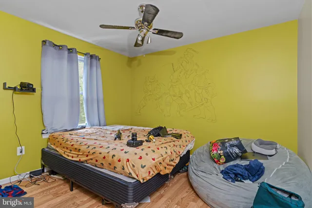 a bedroom with a bed and ceiling fan