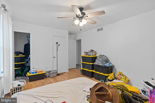 a bedroom with bed and a chandelier
