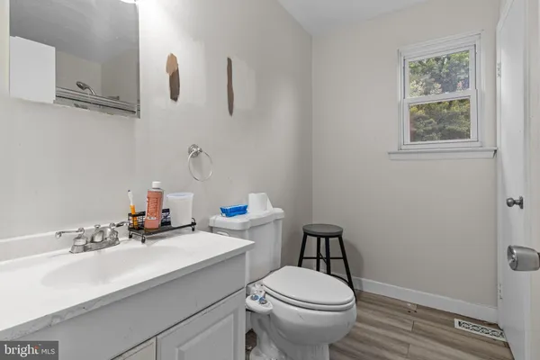 a bathroom with a sink a toilet and mirror