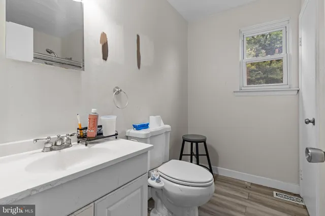 a bathroom with a sink a toilet and mirror