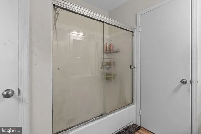 a bathroom with a glass shower door