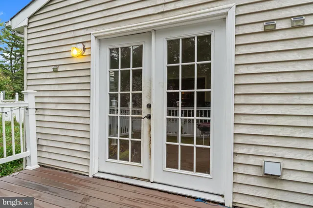 a view of front door with wooden floor and windows