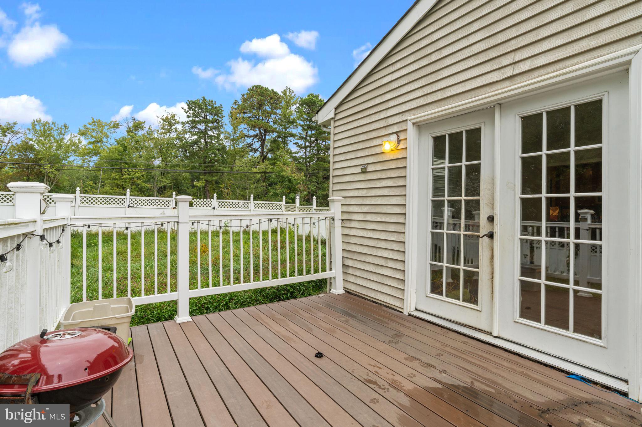 1 Woodhaven Way Sicklerville, NJ 08081 - Photo 30 of 40 a view of a deck with a table and chairs and wooden floor