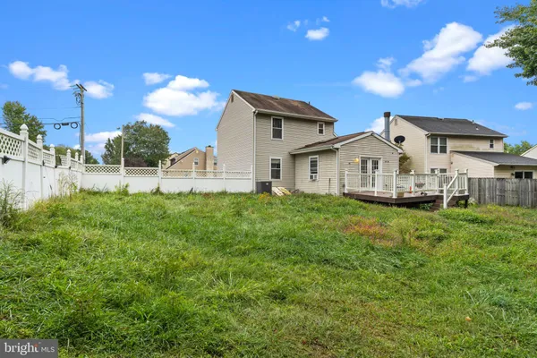 a view of house with backyard and garden
