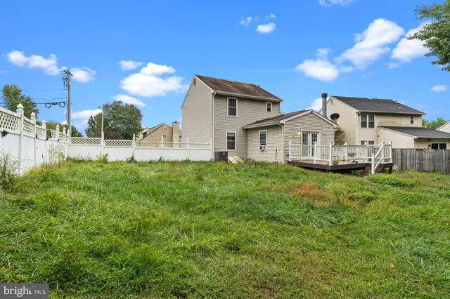 a view of house with backyard and garden