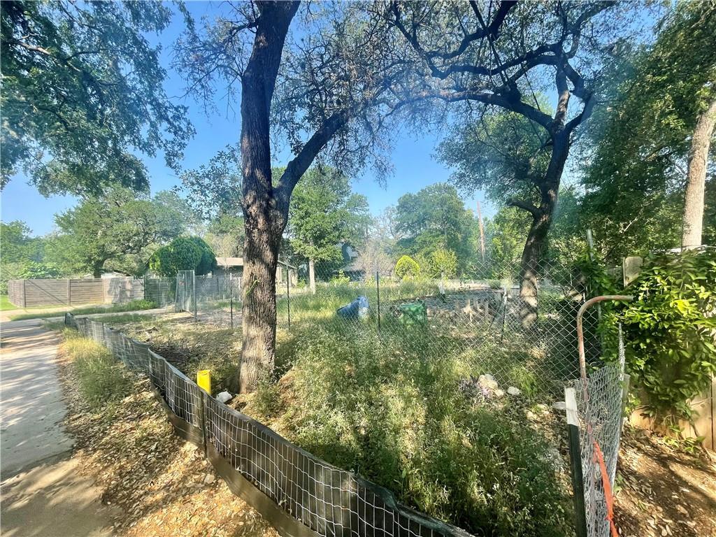 4621 Menchaca Road Austin, TX 78745 - Photo 5 of 7 a backyard of a house with lots of green space
