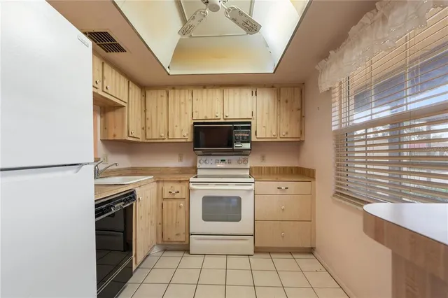 a kitchen with a stove sink and a microwave