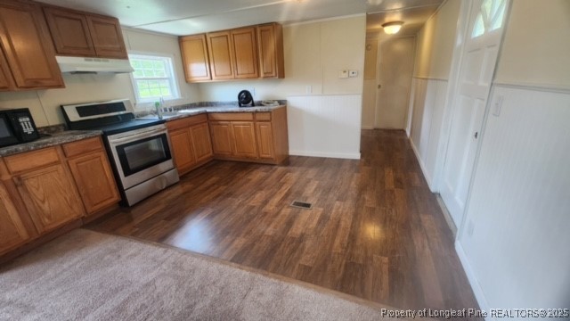 640 Faith Road Pembroke, NC 28372 - Photo 18 of 18 a kitchen with wooden floors and stainless steel appliances