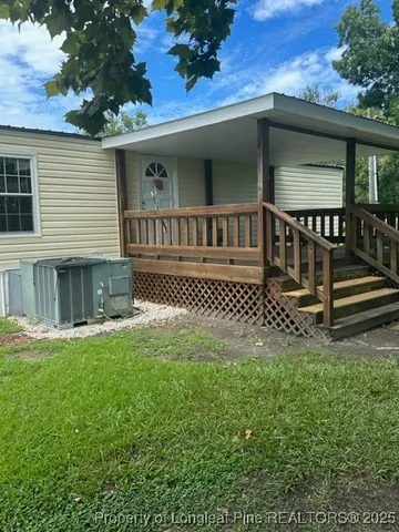 a view of a house with yard and sitting area