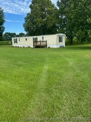 a view of a house with yard and sitting area