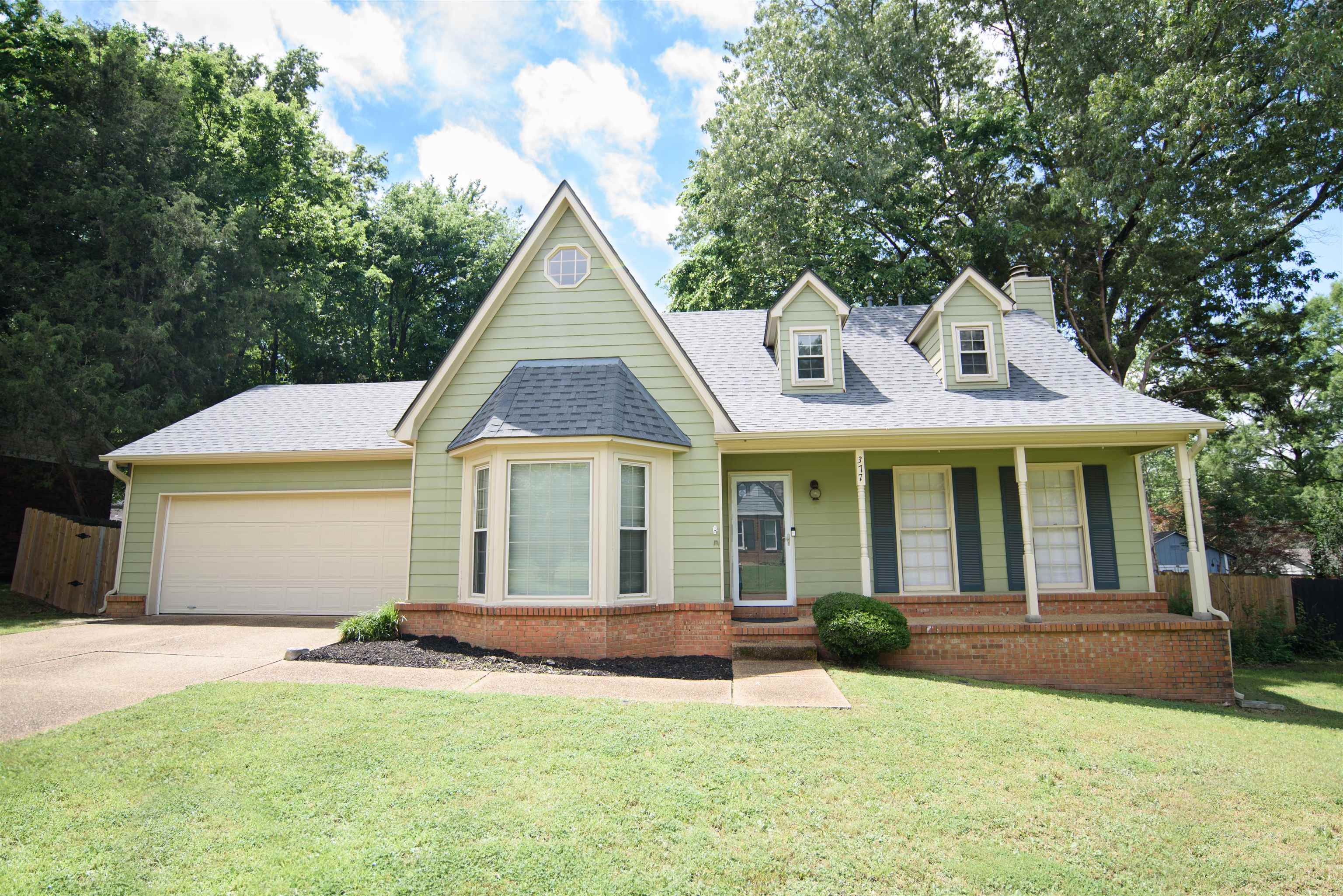 377 Great Falls Road Collierville, TN 38017 - Photo 1 of 16 a front view of a house with a yard