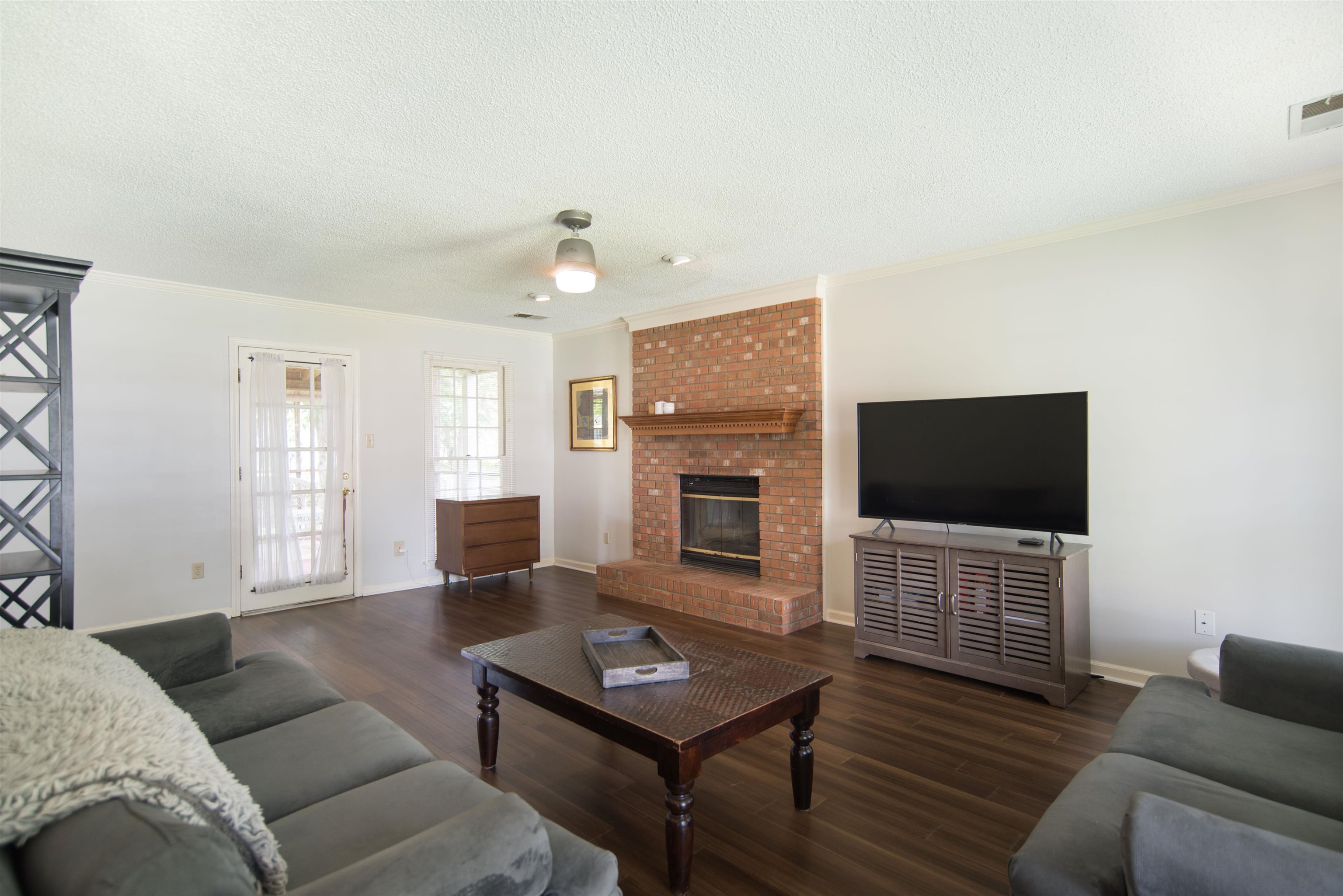 377 Great Falls Road Collierville, TN 38017 - Photo 3 of 16 a living room with furniture a flat screen tv and a fireplace