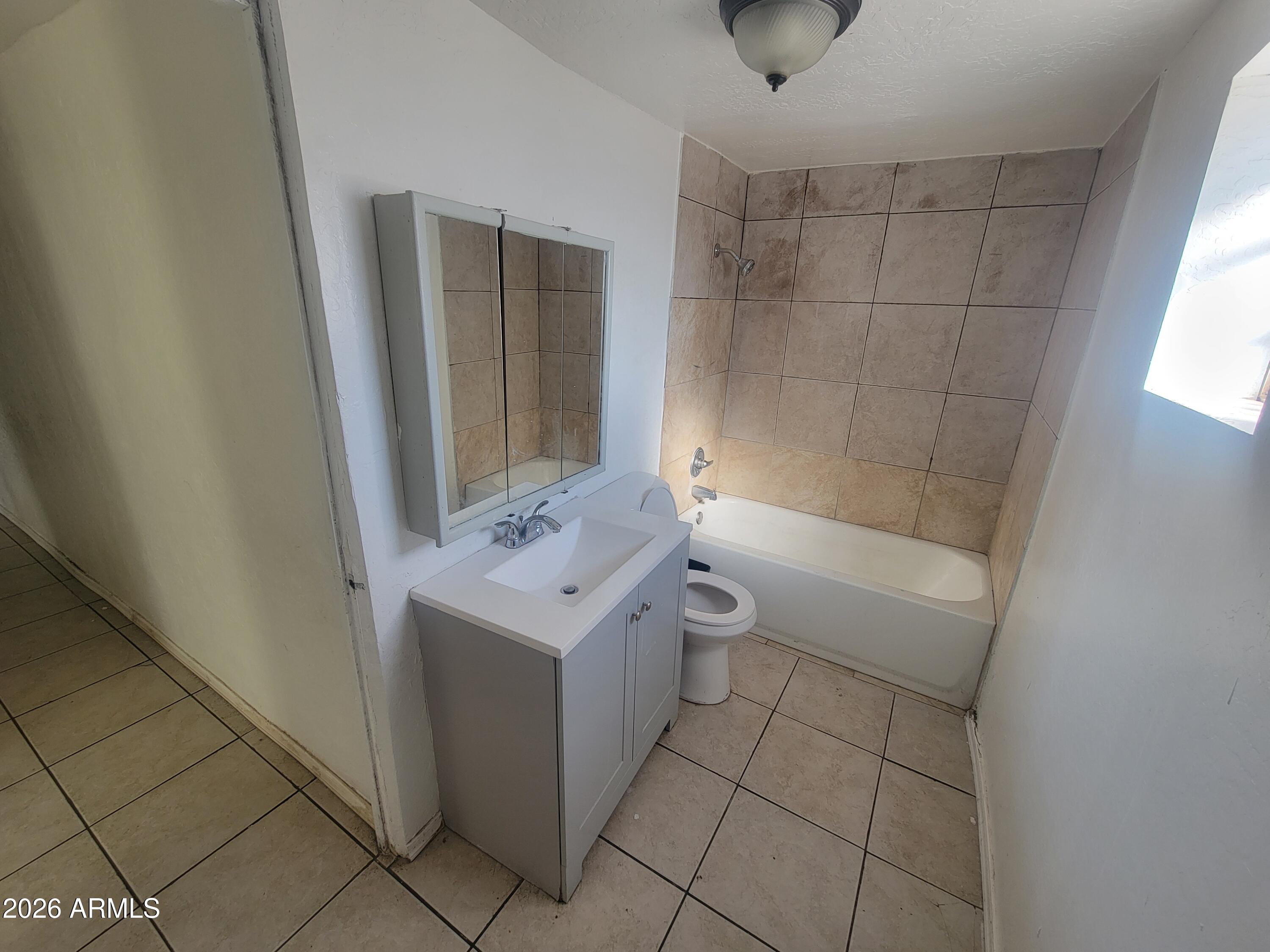 2501 East Jones Avenue Phoenix, AZ 85040 - Photo 16 of 33 a bathroom with a sink a toilet and shower