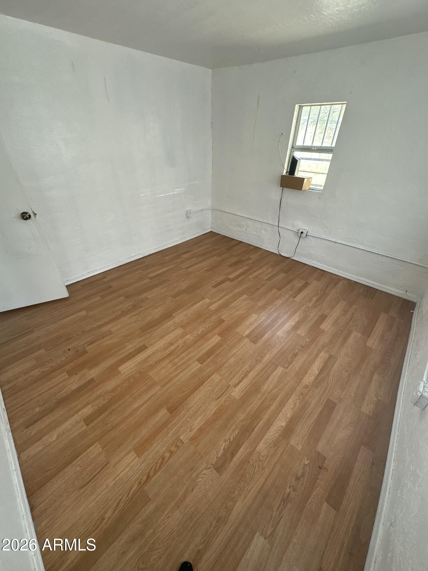 2501 East Jones Avenue Phoenix, AZ 85040 - Photo 22 of 33 wooden floor in an empty room
