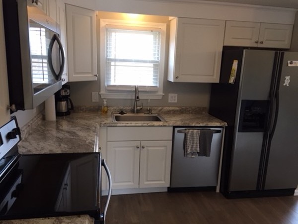 2000 Parker Street Springfield, MA 01128 - Photo 3 of 15 a kitchen with stainless steel appliances granite countertop a sink stove and refrigerator