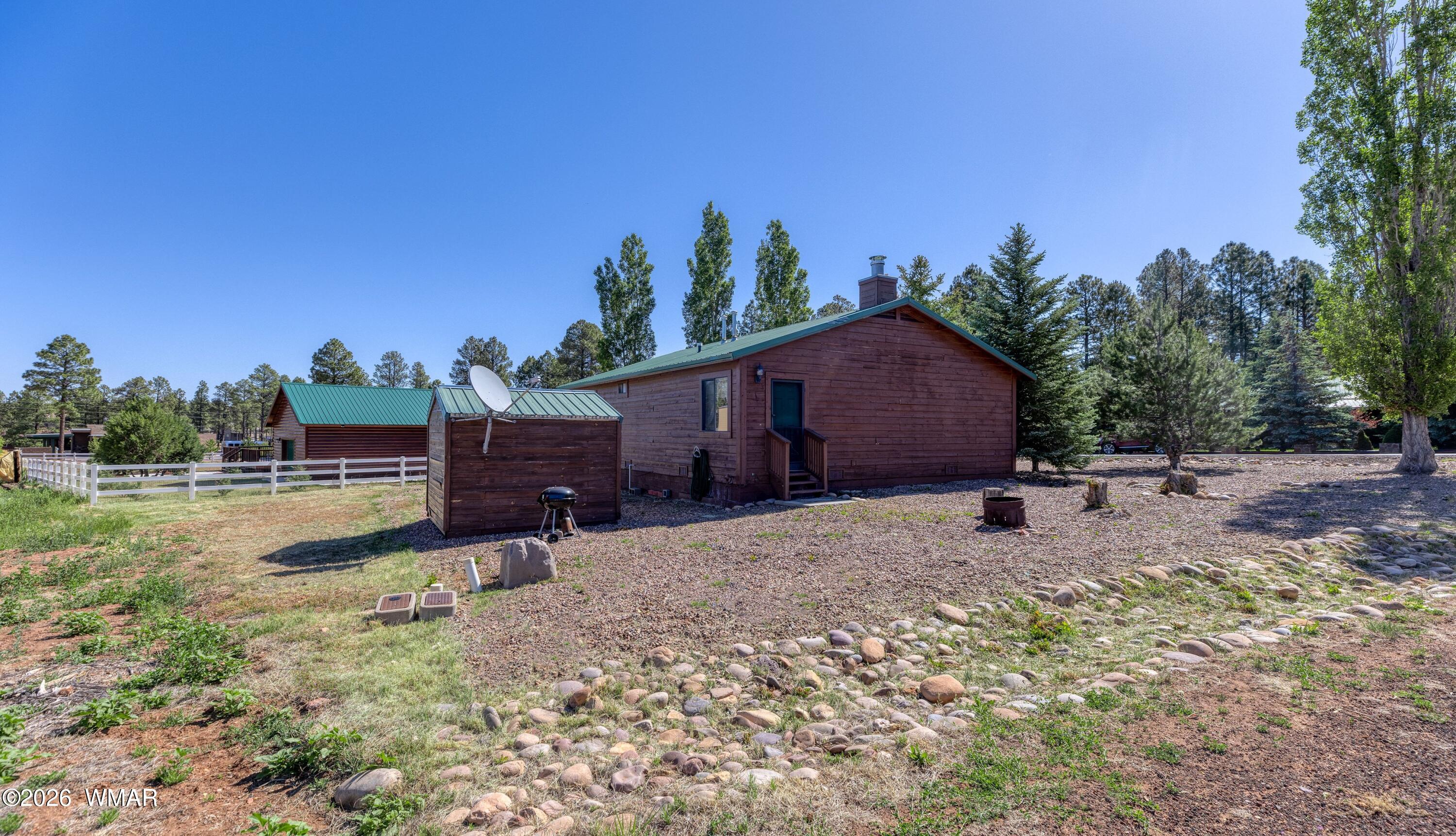 2722 Bain Trail Overgaard, AZ 85933 - Photo 24 of 28 a backyard of a house with lots of green space and outdoor seating
