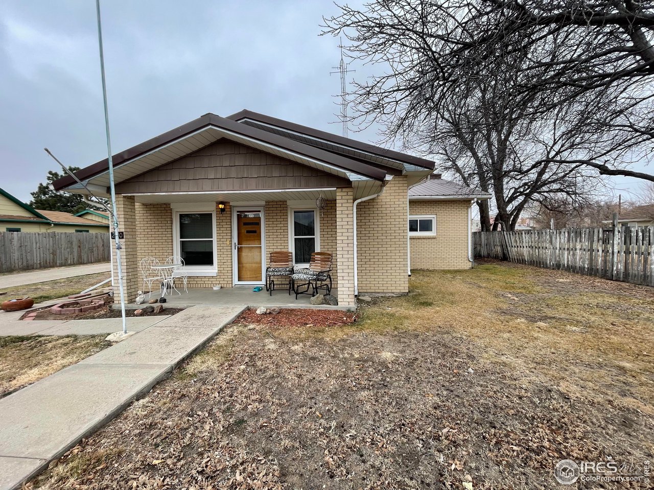 a backyard of a house with table and chairs
