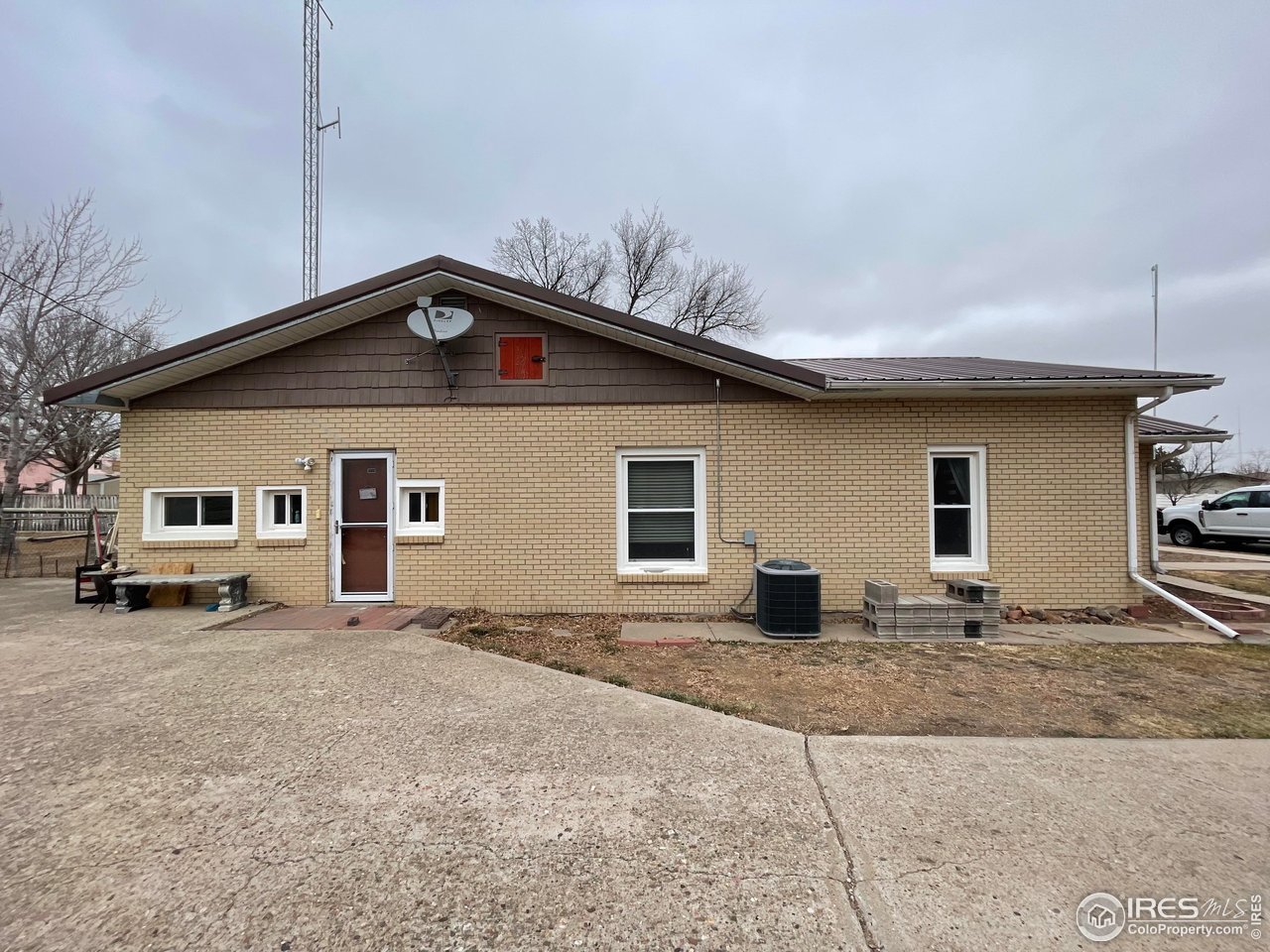 220 New York Avenue Stratton, CO 80836 - Photo 2 of 23 a house that has a sitting area in front of it