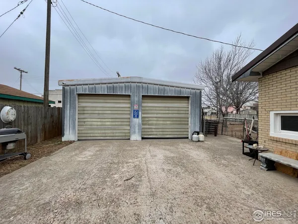 a view of a house with a yard and garage