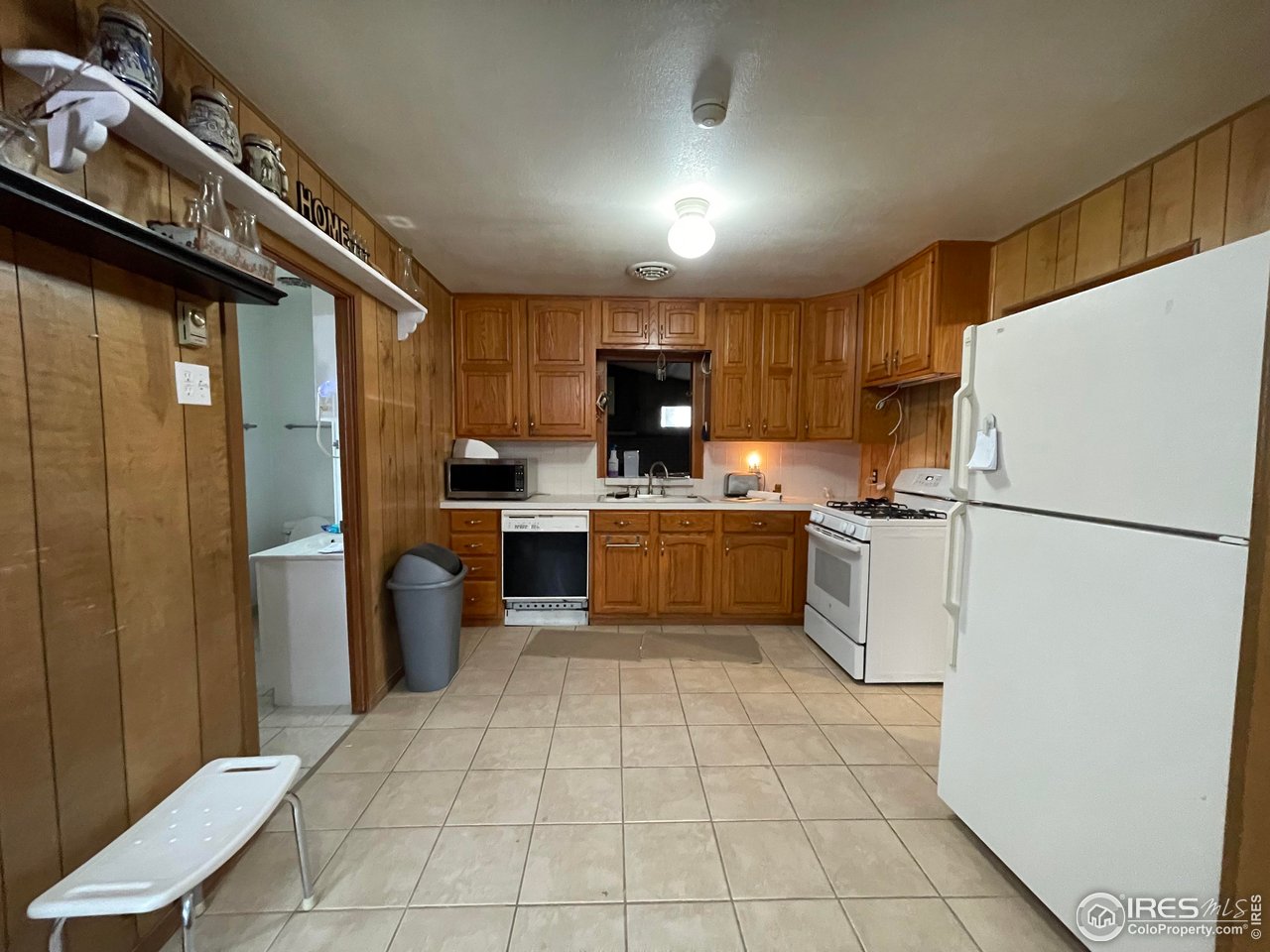 220 New York Avenue Stratton, CO 80836 - Photo 6 of 23 a kitchen with a refrigerator a sink and cabinets