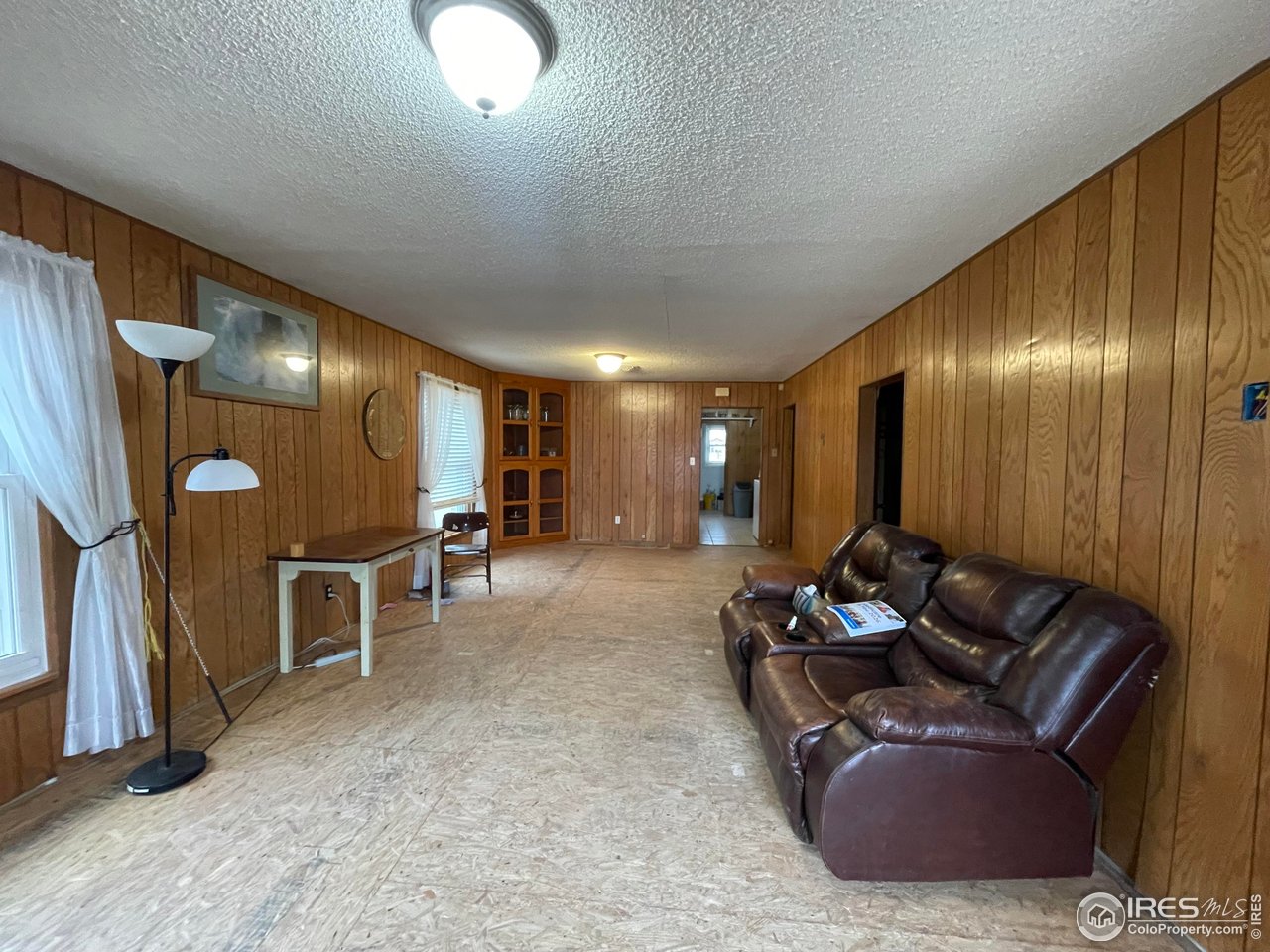 220 New York Avenue Stratton, CO 80836 - Photo 8 of 23 a lobby with furniture and a projector