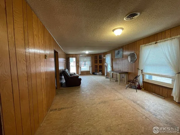 a view of a hallway with seating area