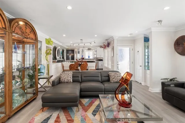 a dining room with furniture and a wooden floor