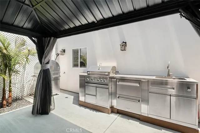 a view of a chairs and table in the backyard