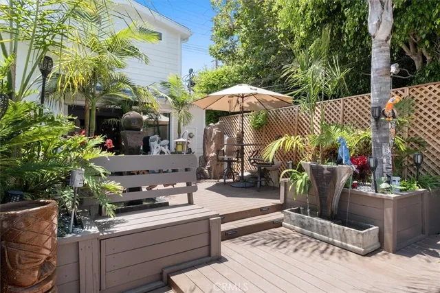 a view of a patio with table and chairs potted plants and large tree