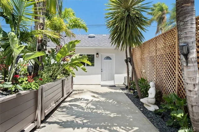 a view of a kitchen with refrigerator and a sink