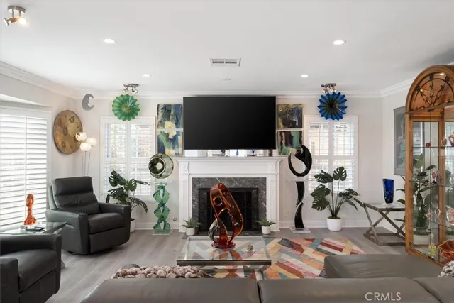 an empty room with windows fireplace and wooden floor