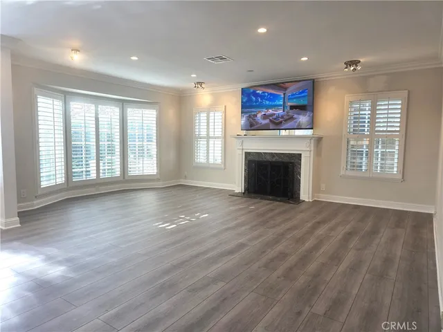 a living room with furniture a fireplace and a large window
