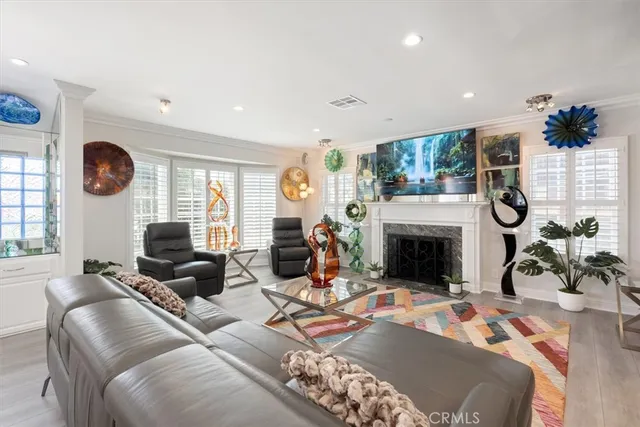 an empty room with wooden floor and a fireplace