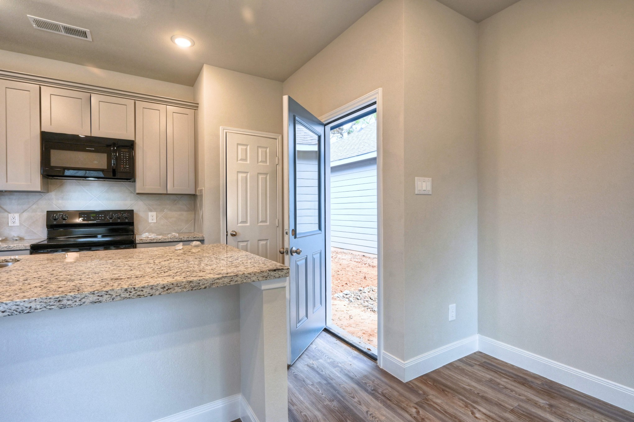 9173 Inwood Willis, TX 77318 - Photo 8 of 31 a kitchen with granite countertop a refrigerator and a stove top oven