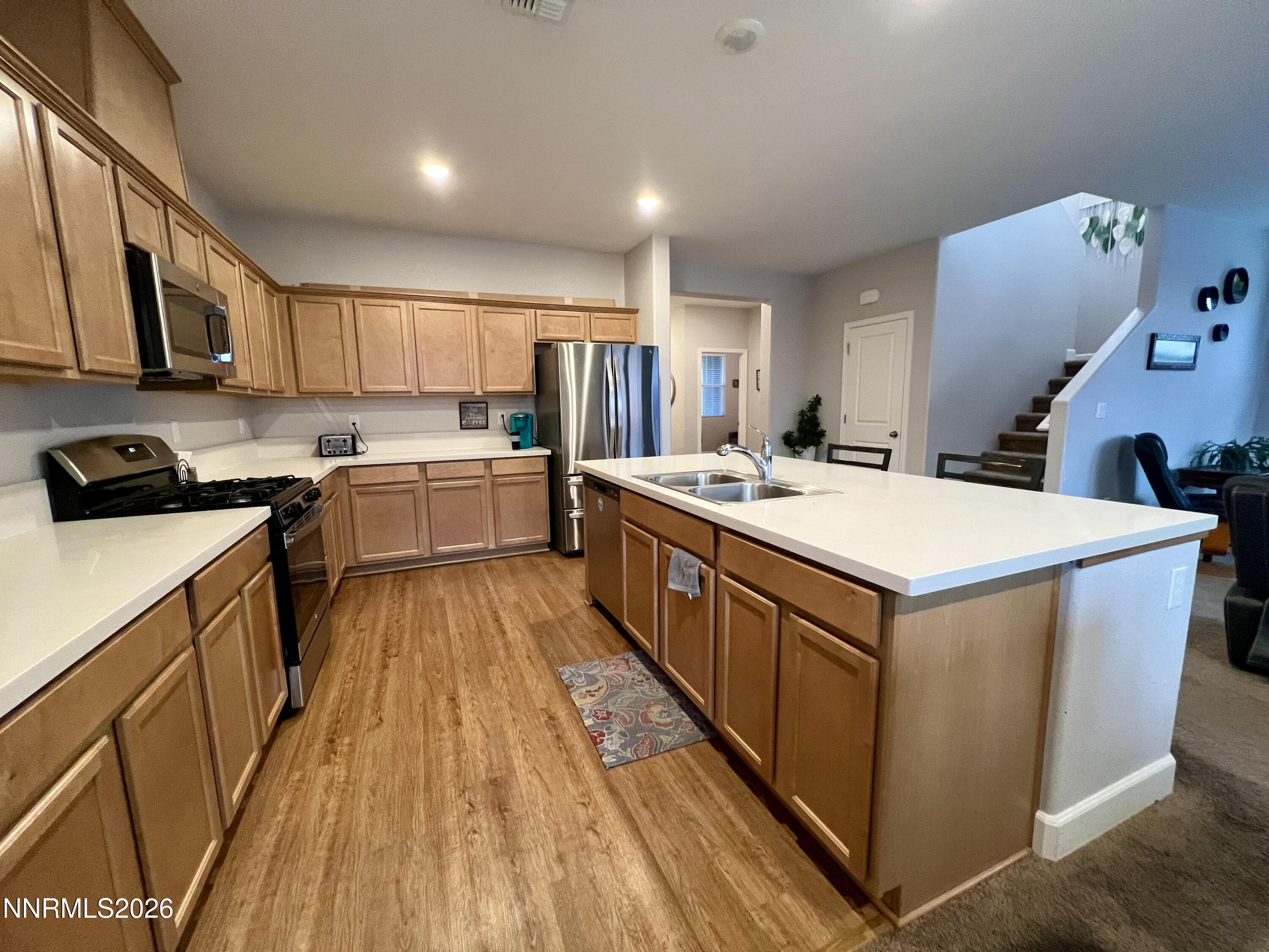 9355 Bay Drive Reno, NV 89506 - Photo 23 of 42 a kitchen with a sink stove top oven and cabinets