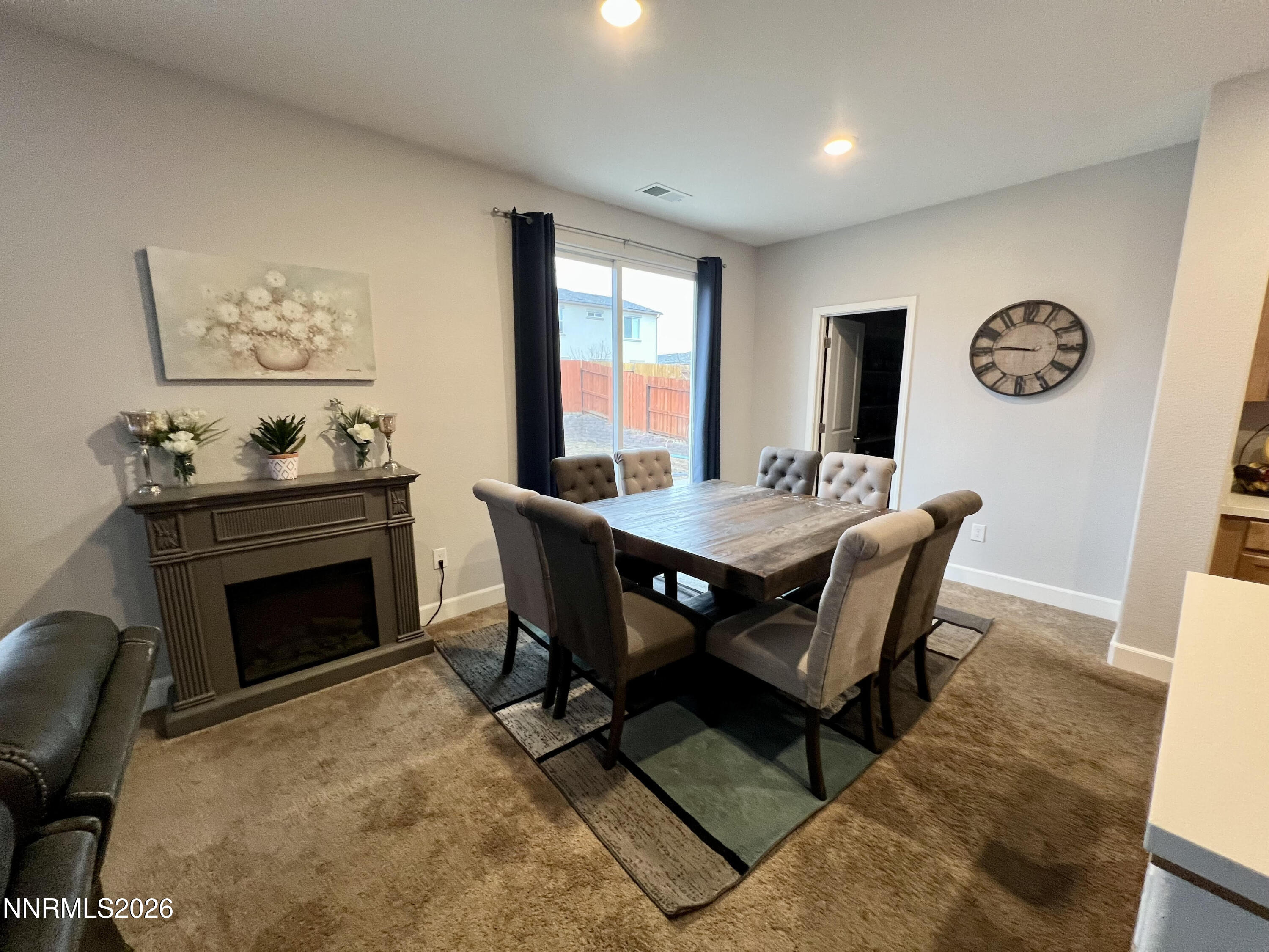 9355 Bay Drive Reno, NV 89506 - Photo 24 of 42 a dining room with furniture a rug and a fireplace