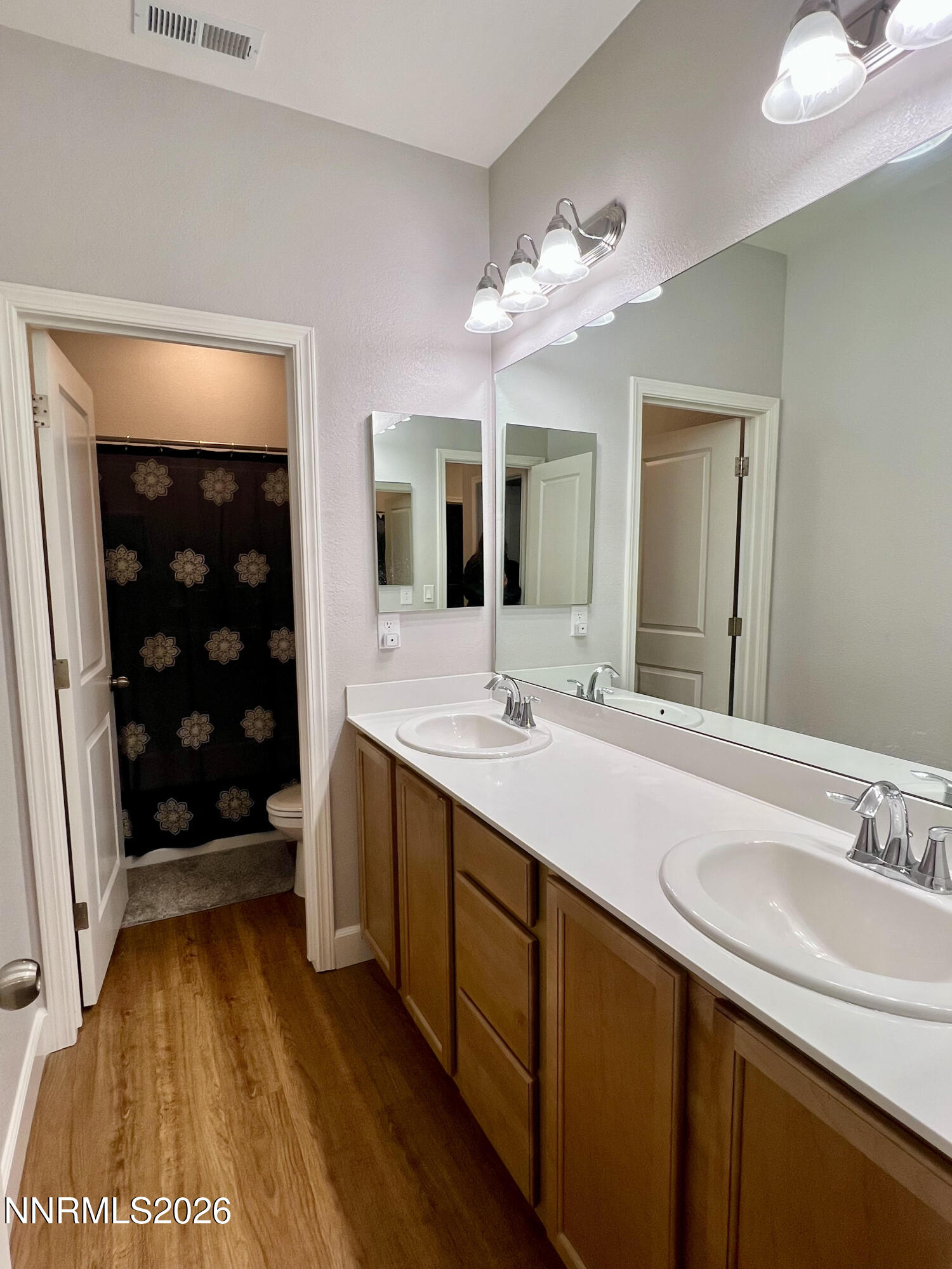 9355 Bay Drive Reno, NV 89506 - Photo 32 of 42 a bathroom with a double vanity sink and a mirror