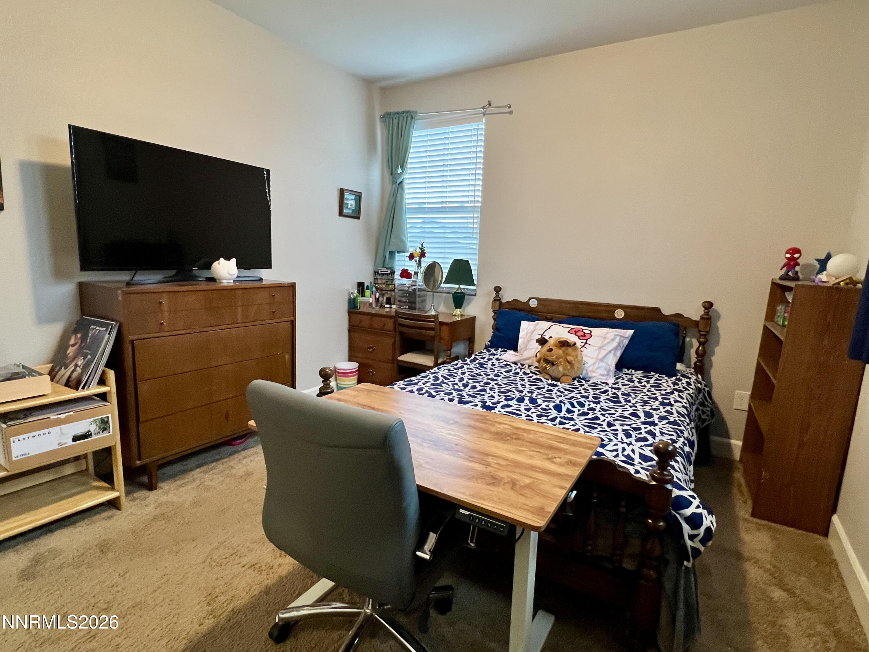 9355 Bay Drive Reno, NV 89506 - Photo 34 of 42 a bedroom with a bed and a flat screen tv