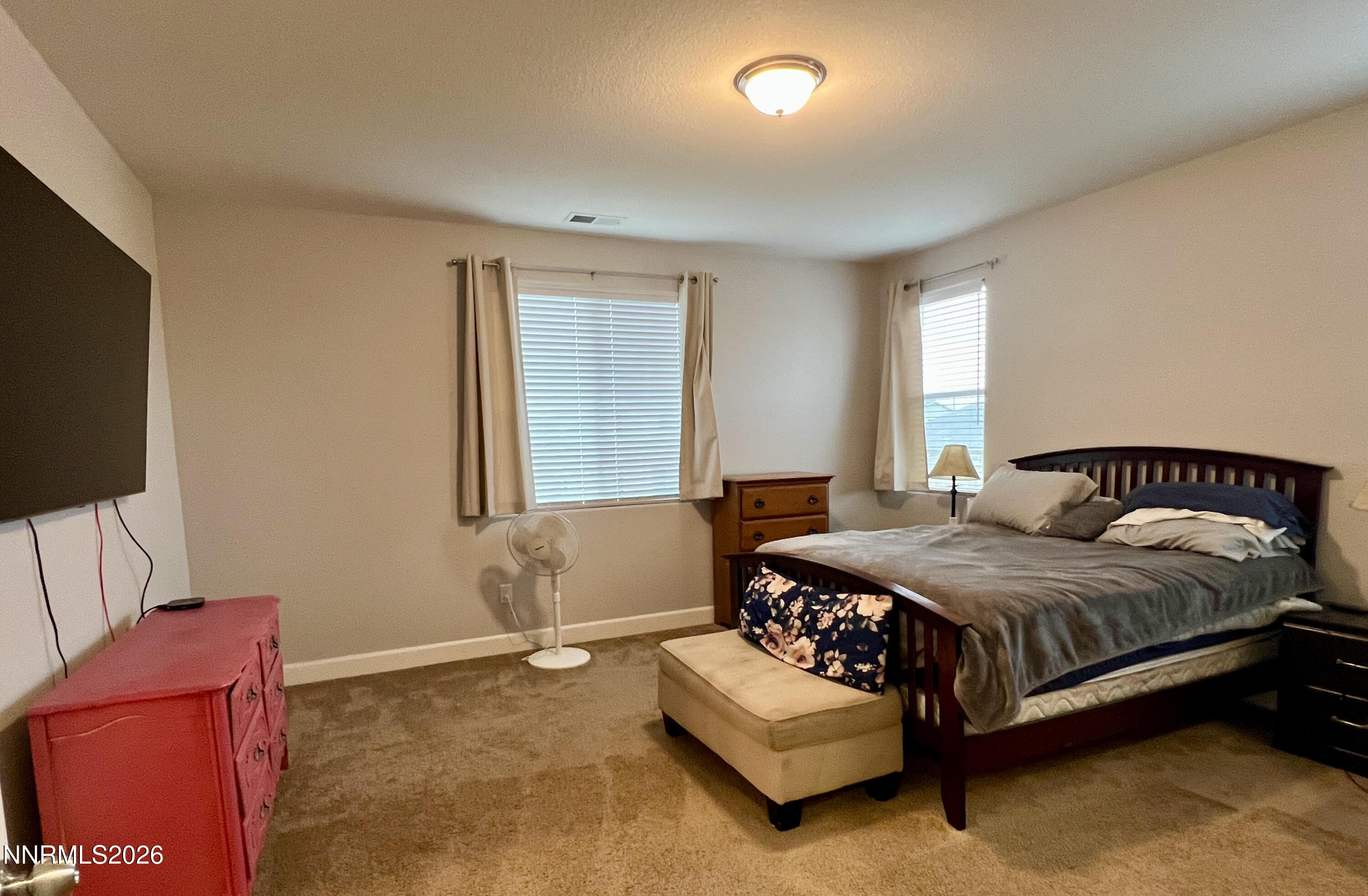 9355 Bay Drive Reno, NV 89506 - Photo 37 of 42 a bedroom with a bed couch and a flat screen tv