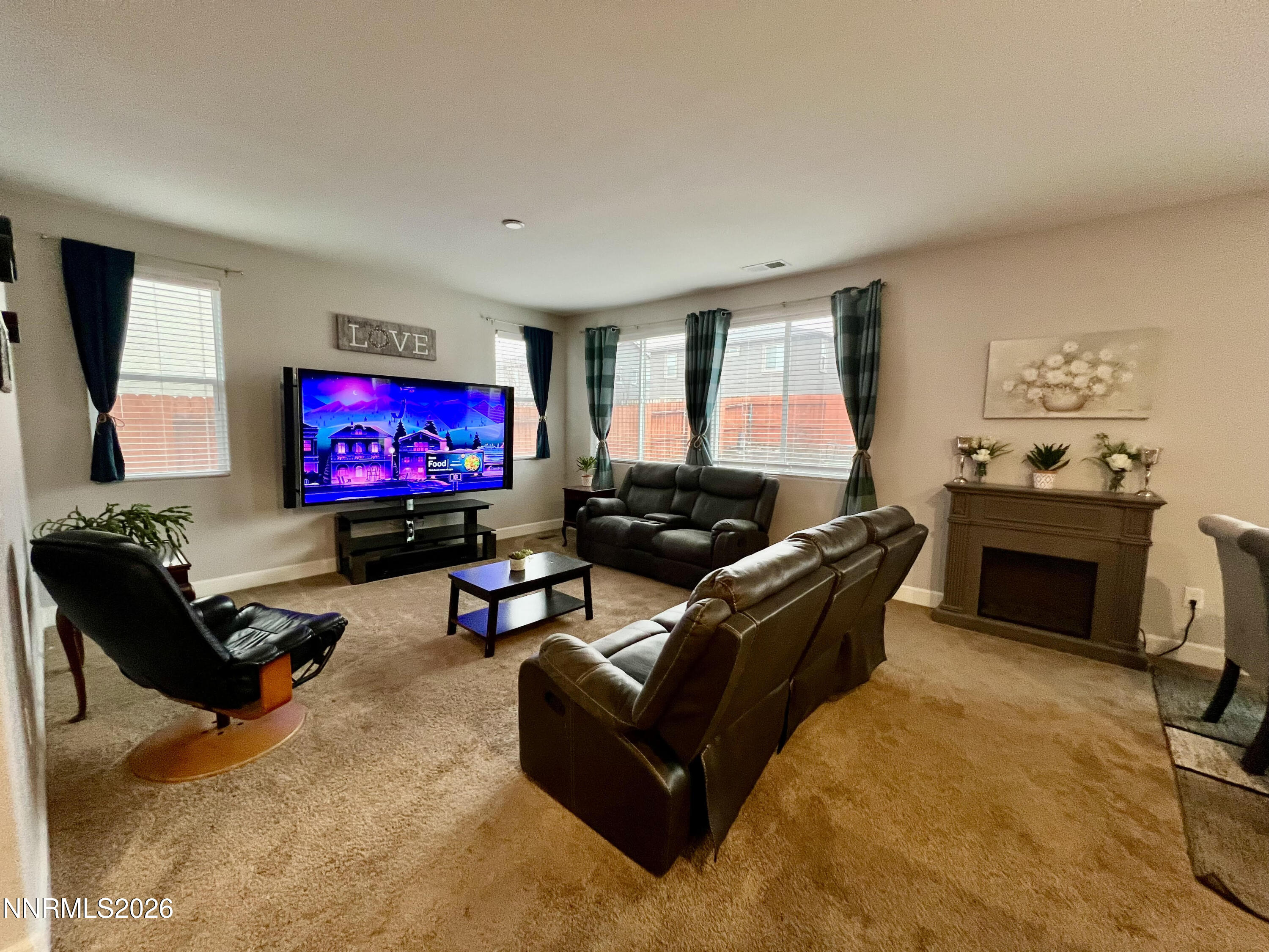 9355 Bay Drive Reno, NV 89506 - Photo 8 of 42 a living room with furniture a flat screen tv and a fireplace