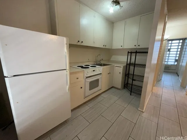 a kitchen with stainless steel appliances a refrigerator sink and cabinets