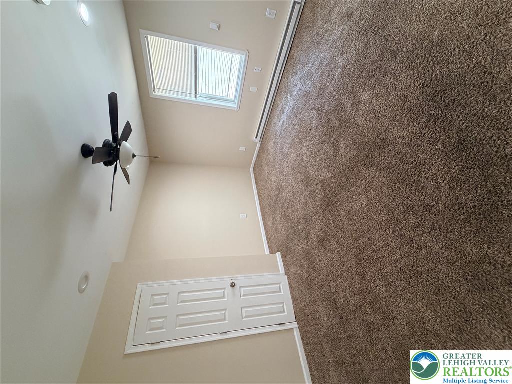718 Ferry Street Easton, PA 18042 - Photo 14 of 37 A skylight and high ceilings amplify the airy feel of this carpeted interior.
